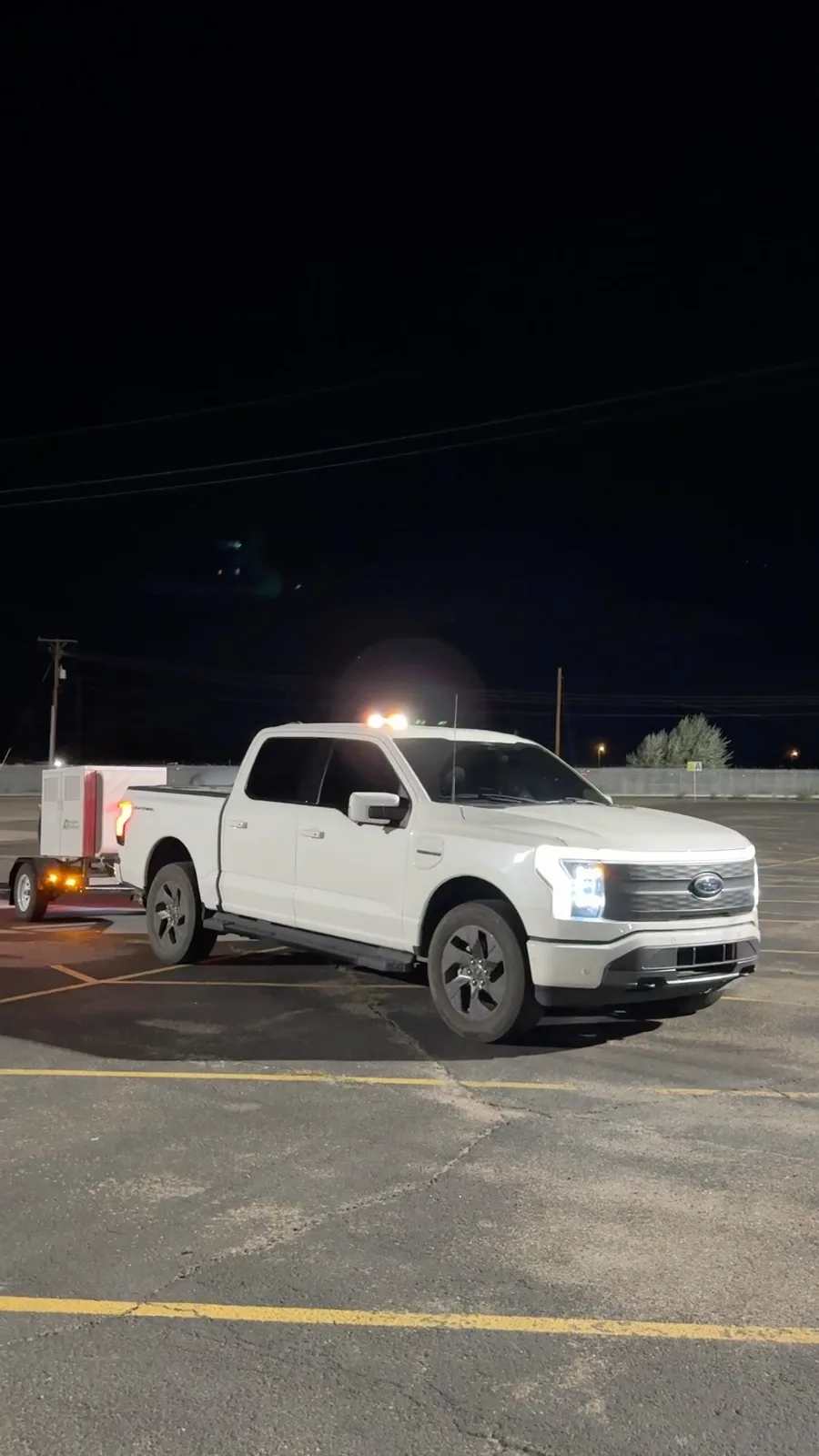 Anytime Recharge truck and charging trailer photographed at night